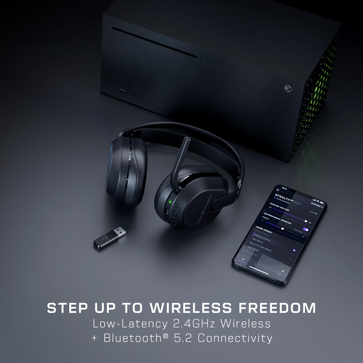Gaming console, wireless headphones, USB adapter, and smartphone on a dark surface with text 'Step Up to Wireless Freedom'.