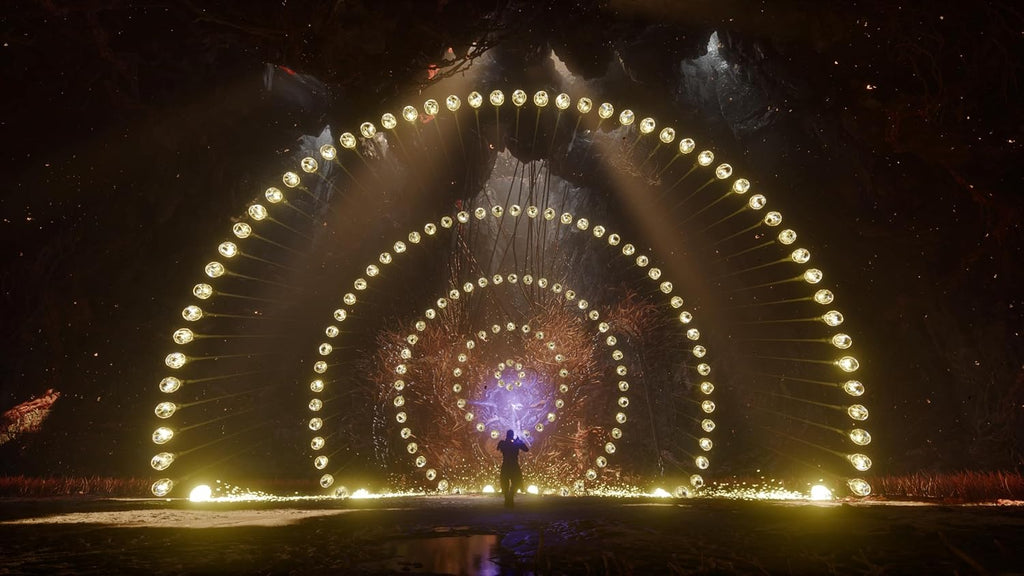 Large illuminated archway with concentric circles and a person standing underneath at night.